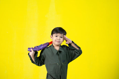 Image for a kid playing with a toy gun
