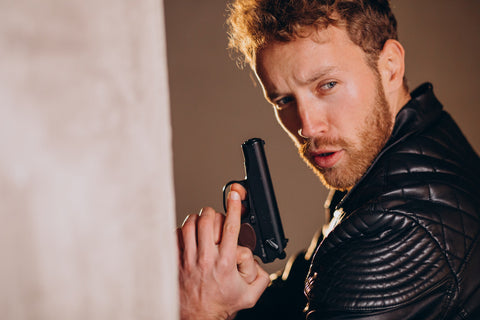 Image of a man holding a gun with both hand