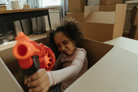 girl playing with toy gun