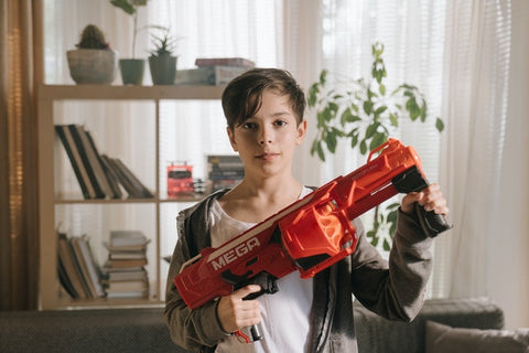 kid holding a toy gun