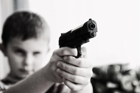 kid holding toy gun