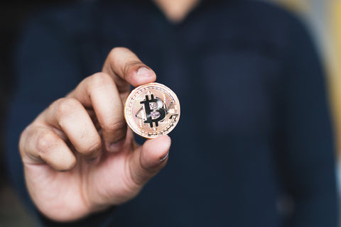 Man holding bitcoin coin