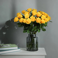 Bouquet of yellow roses in glass vase