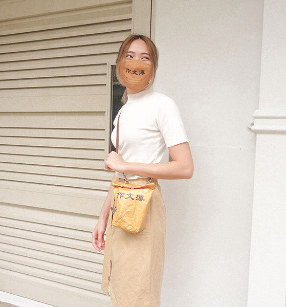 girl carrying wheniwasfour chinese compo kraft paper sling bag with matching mask 