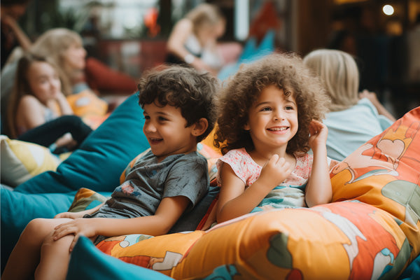 Two kids sitting on a bean bag chair