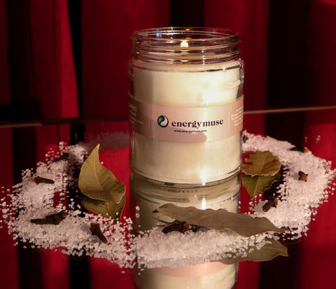 candle with salt, cloves and bay leaves for holiday energy reset by Energy Muse