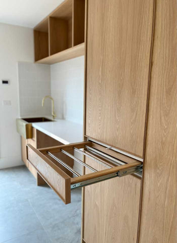 Custom Laundry Cabinetry in American Oak with pull out Drying Rack