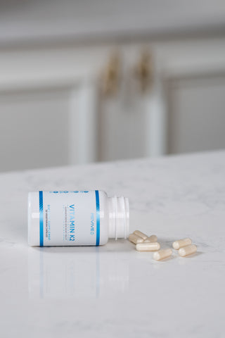 Revive's Vitamin K2 supplement laid out on a counter