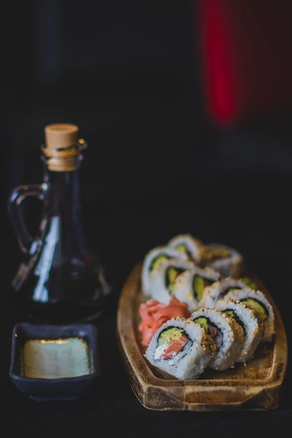 A roll of sushi on a wooden tray