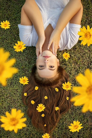 An upside-down photo of a woman with flowers in her hair