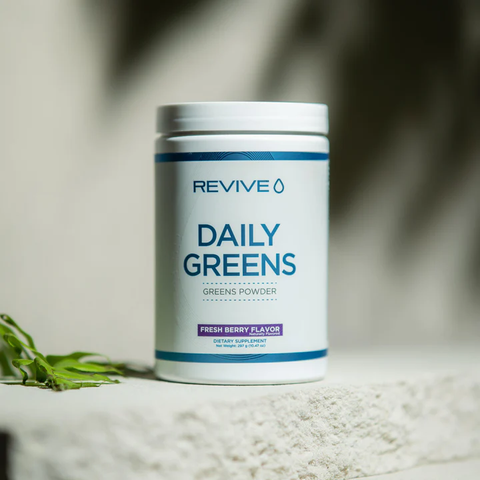 A white tub of Revive’s Daily Greens powder