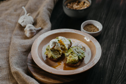 A piece of gluten-free bread, with avocado and egg on top