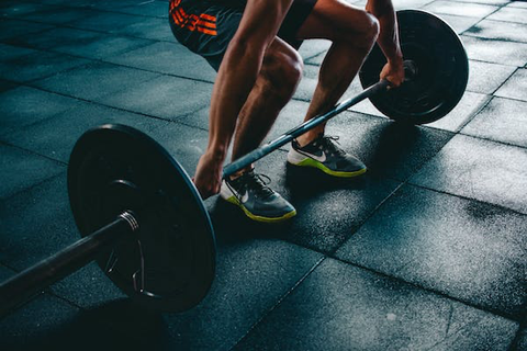 A person squatting and lifting weights