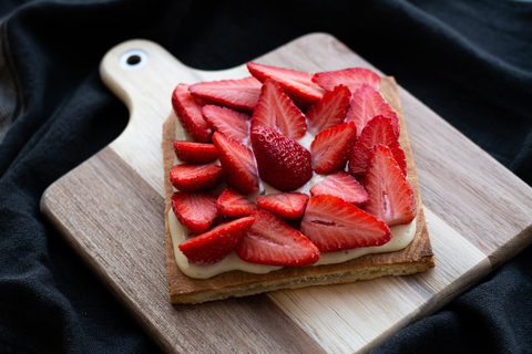 Sliced strawberries on a wooden board