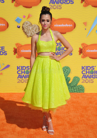 Megan Nicole in a slime green sequin two piece pinup look by Julie Mollo at the nickelodeon kids choice awards
