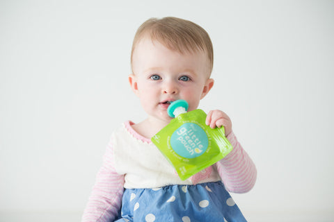 Parker, daughter of Little Green Pouch co-founder Melissa Winn, enjoys a snack from a Really Little Green Pouch