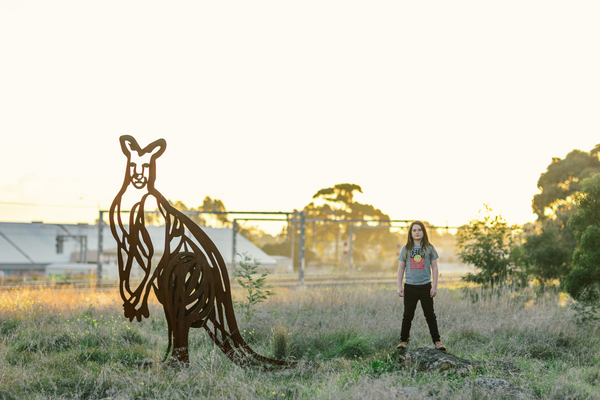 A Kangaroo sculpture and a tween wearing a pair of DHAGUN. Image taken by Hyggelig Photography