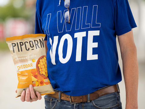 Voter holding Pipcorn Cheese Balls