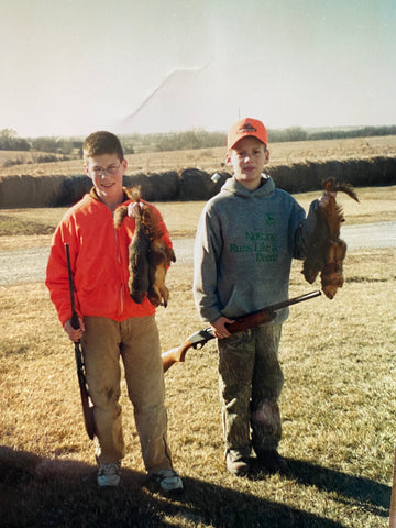 Colton and friend holding squirrels they harvested