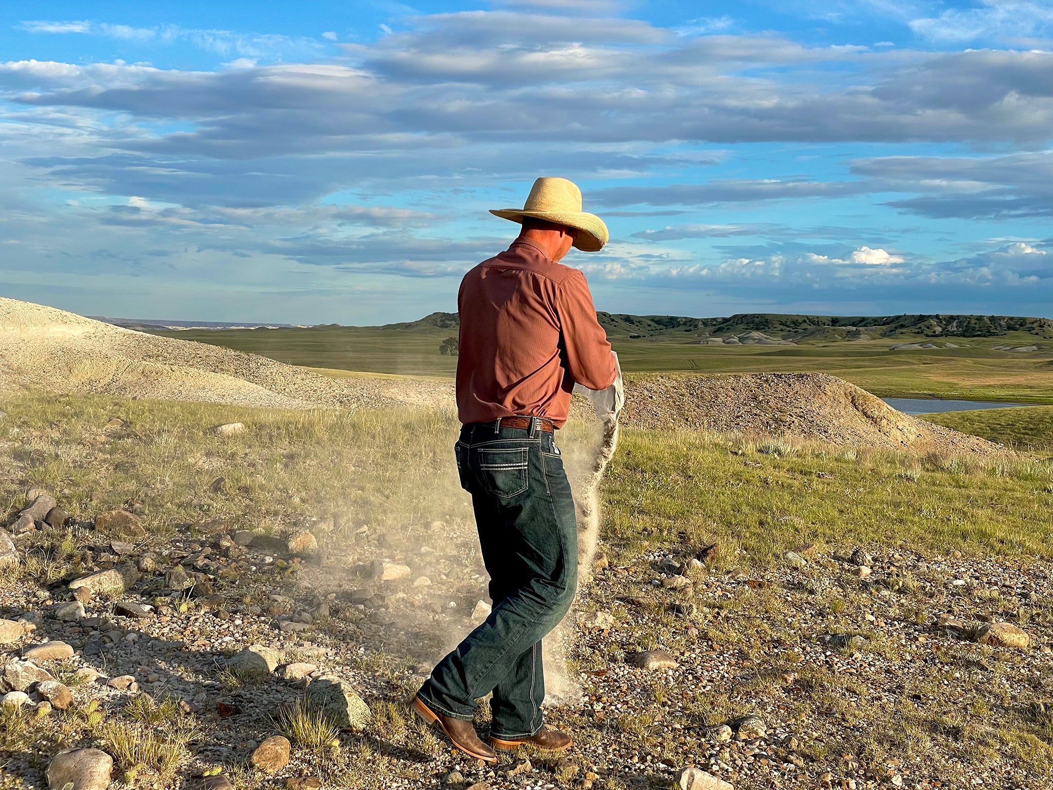 Colton Jones spreading ashes on the prairie