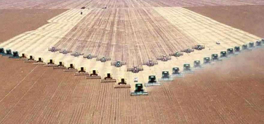 Industrial agriculture plowing brown field