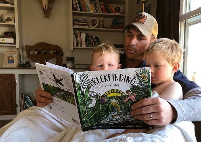 Colton Jones reading Creekfinding to two children