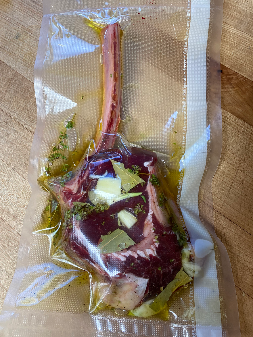 buffalo bone-in ribeye in a ziploc bag with marinade