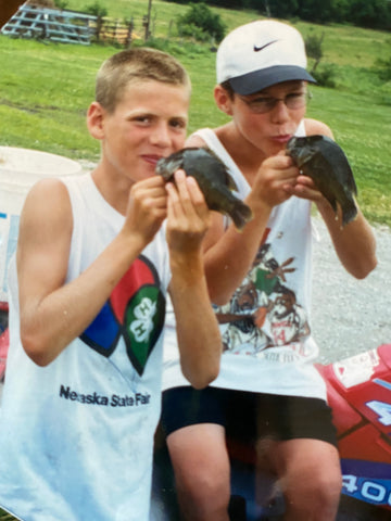 Colton and friend kissing fishes they caught