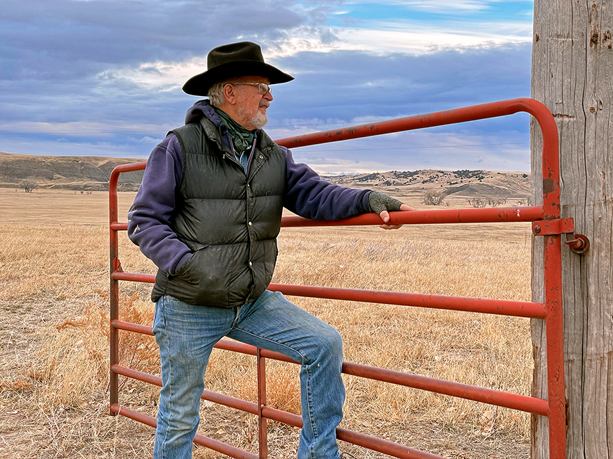 gervase standing at a gate on the ranch