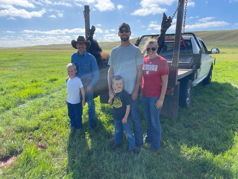 Family standing in front of harvest pickup