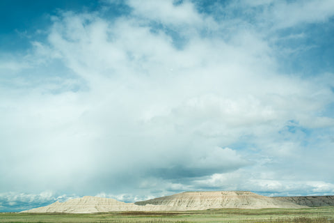 picture of Badlands National Park rock formation with white clouds in the background