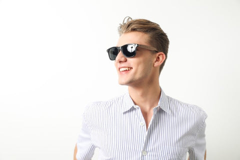 guy in white round neck long sleeves shirt wearing a wooden sunglasses