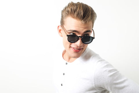 guy in white round neck long sleeves shirt wearing a wooden sunglasses