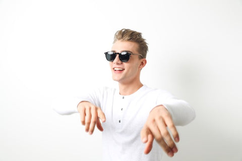 guy in white round neck long sleeves shirt wearing a wooden sunglasses