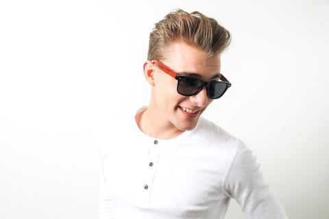 guy in white round neck long sleeves shirt wearing a wooden sunglasses