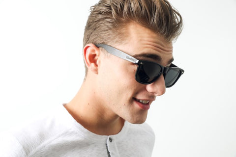guy in white round neck long sleeves shirt wearing a wooden sunglasses