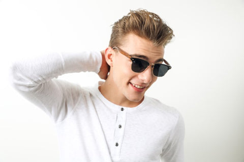 guy in white round neck long sleeves shirt wearing a wooden sunglasses