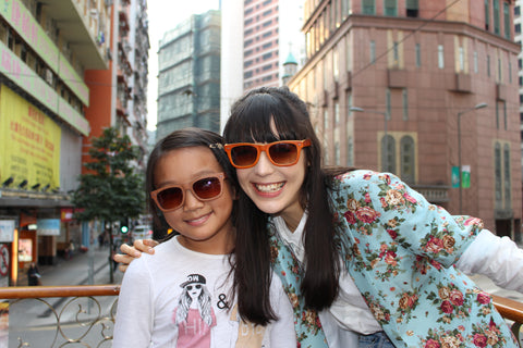 2 girls wearing sunglasses in the city