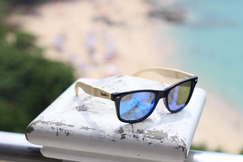 wooden sunglasses in the shade of blue on a ceramic post