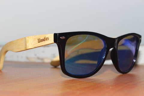 wooden sunglasses in the shade of blue on the sand