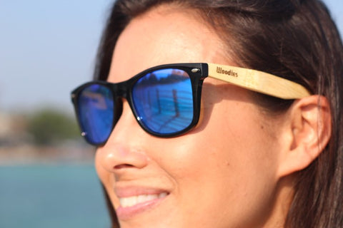 girl wearing woodies wooden sunglasses in the shade of blue