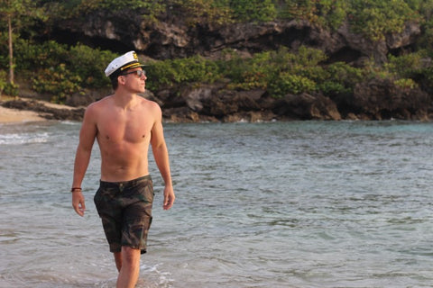 guy wearing a captain's hat and wooden sunglasses