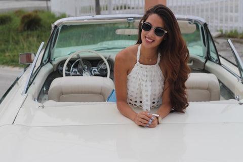 girl in sunglasses on a white convertible car