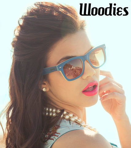 girl wearing pink lipstick with pearl necklace wearing blue wooden sunglasses