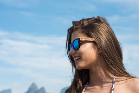 girl with long hair wearing a wooden blue shade sunglasses