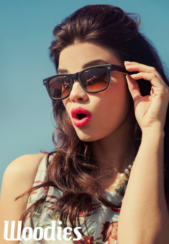 girl wearing dark blue sunglasses in red lipstick posing for a shot