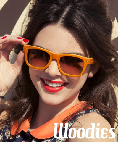 girl wearing orange sunglasses in red lipstick posing for a shot