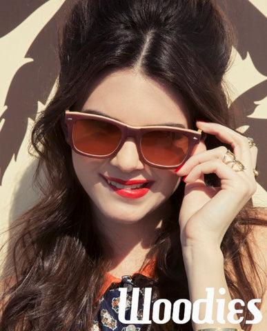 girl wearing dark brown sunglasses in red lipstick posing for a shot