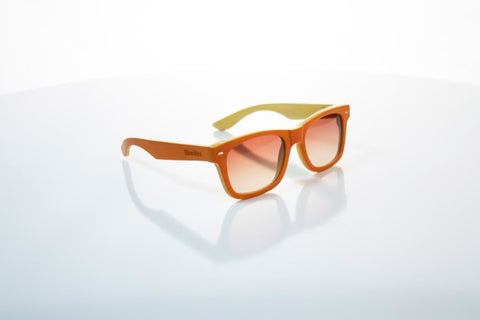 orange wooden sunglasses with the brand woodies in the shade of brown