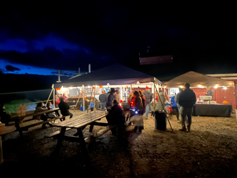 Wood's Vermont Maple Sugar House tent lite up and filled with food and Vermont Maple Products at our Annual Pumpkin Walk.